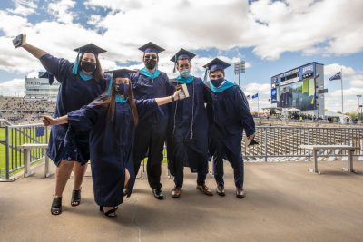 At front Alexandra DeGirolarno ’21 MPA, back row from left Ciara Hanlon ’21 MPA, Michael Lucas ’21 MPA, Kevin Fitzgerald ’21 MPA, and Devon Aldave ’21 MPA at the 2021 Masters/ 6th year certificate Commencement ceremony at Pratt & Whitney, Rentshler Field on May 12, 2021.