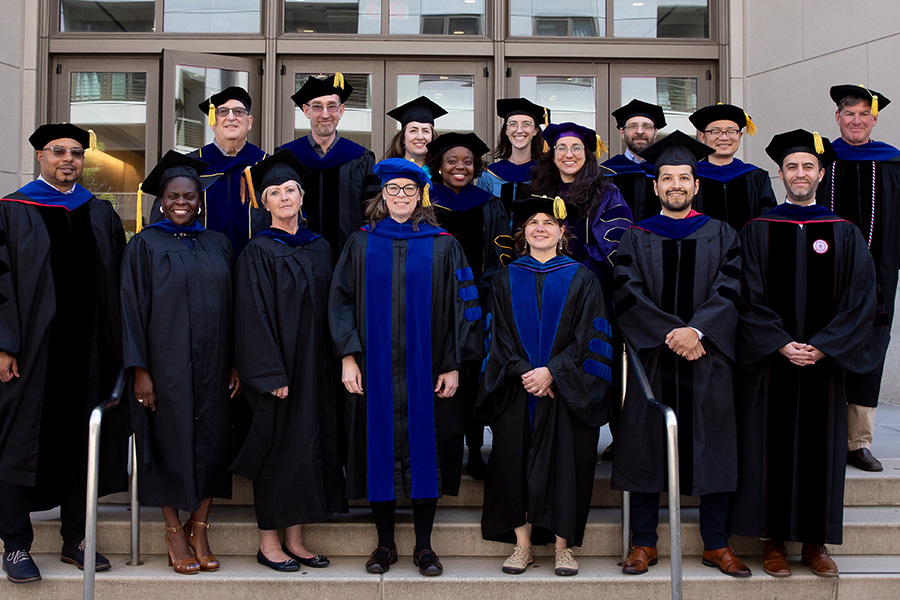 A group photo of faculty in regalia during commencement.