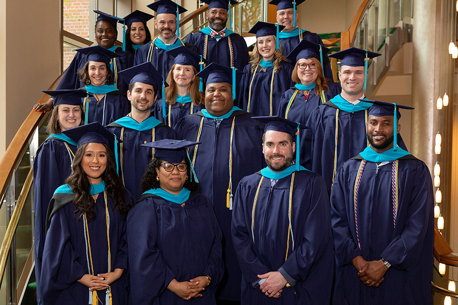 A group photo of graduates in caps and gowns at commencement.  