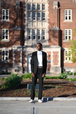 a man standing in front of of an academic building