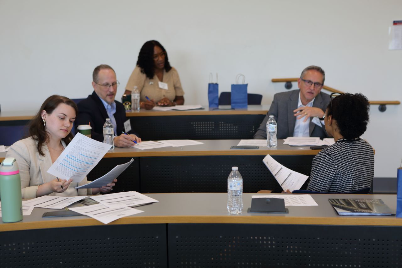 Photo of local public service professionals sitting in a classroom, serving as judges for undergraduate students competing in UConn SPP Local Government Management case competition in June 2026.